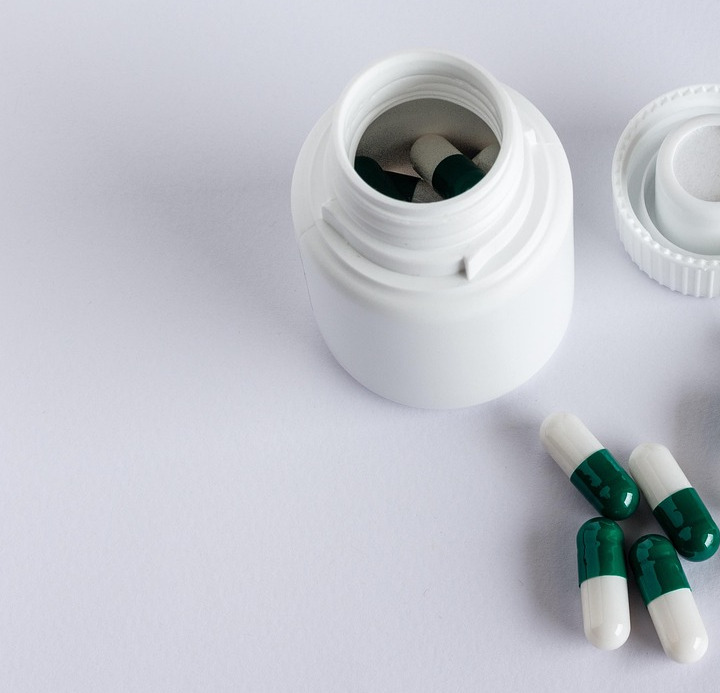 Pharmacist arranging medicine shelves